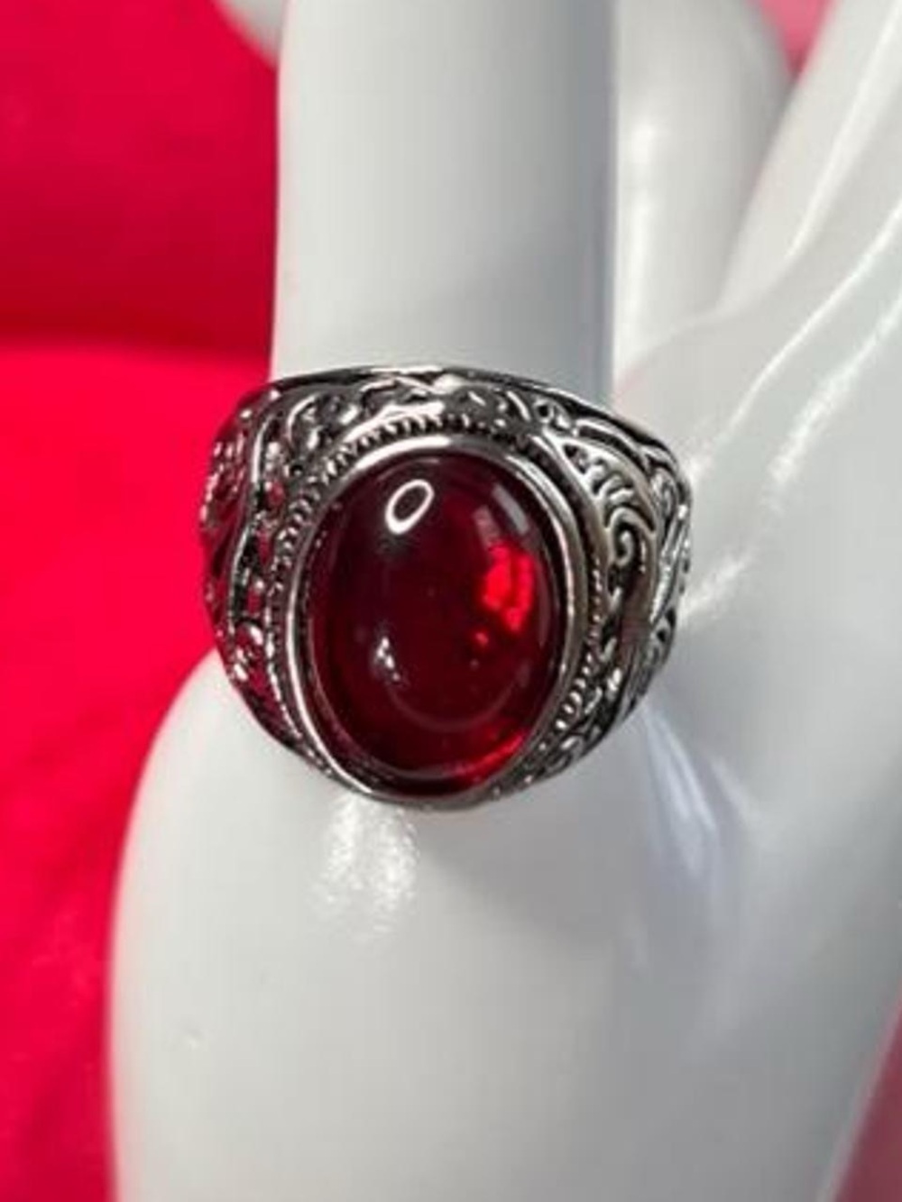 Red ruby gemstone ring with silver filigree detailing